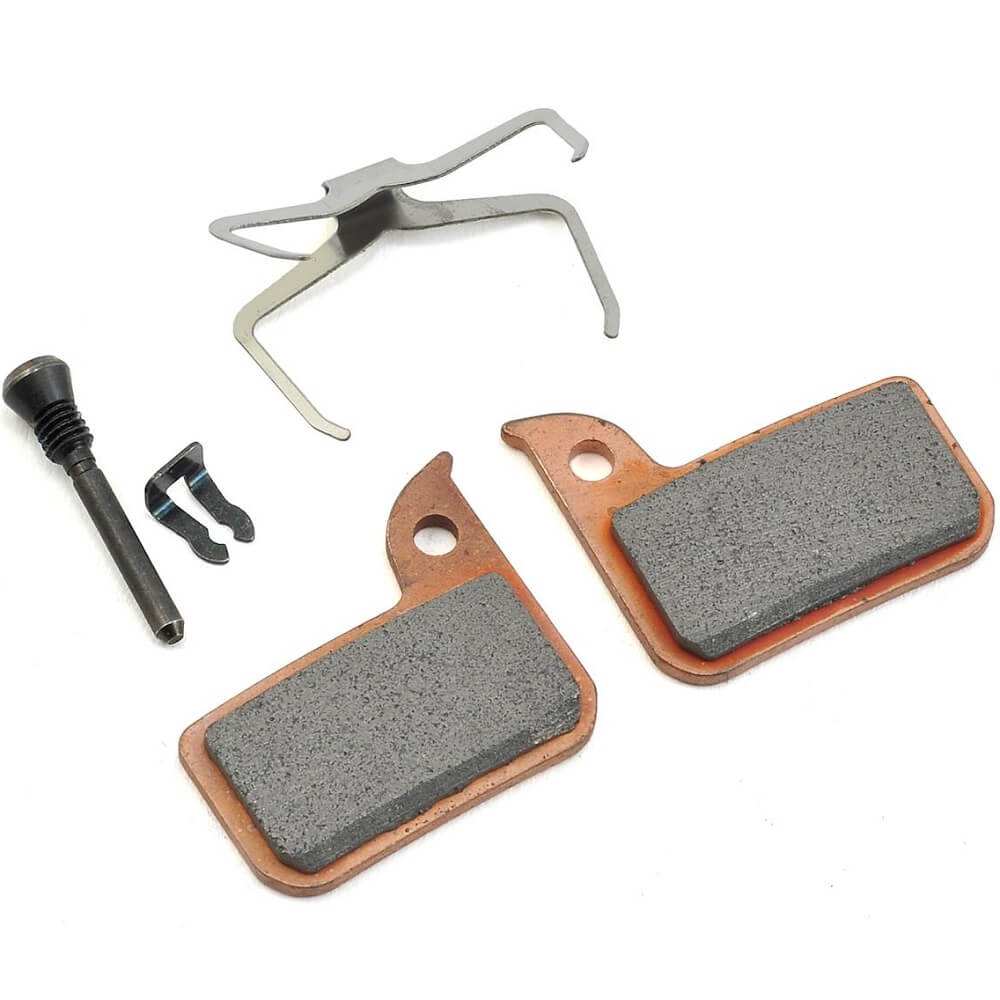 Copper colored sintered SRAM Road CX HRD Disc Brake Pads with spring, clip and pin against white background