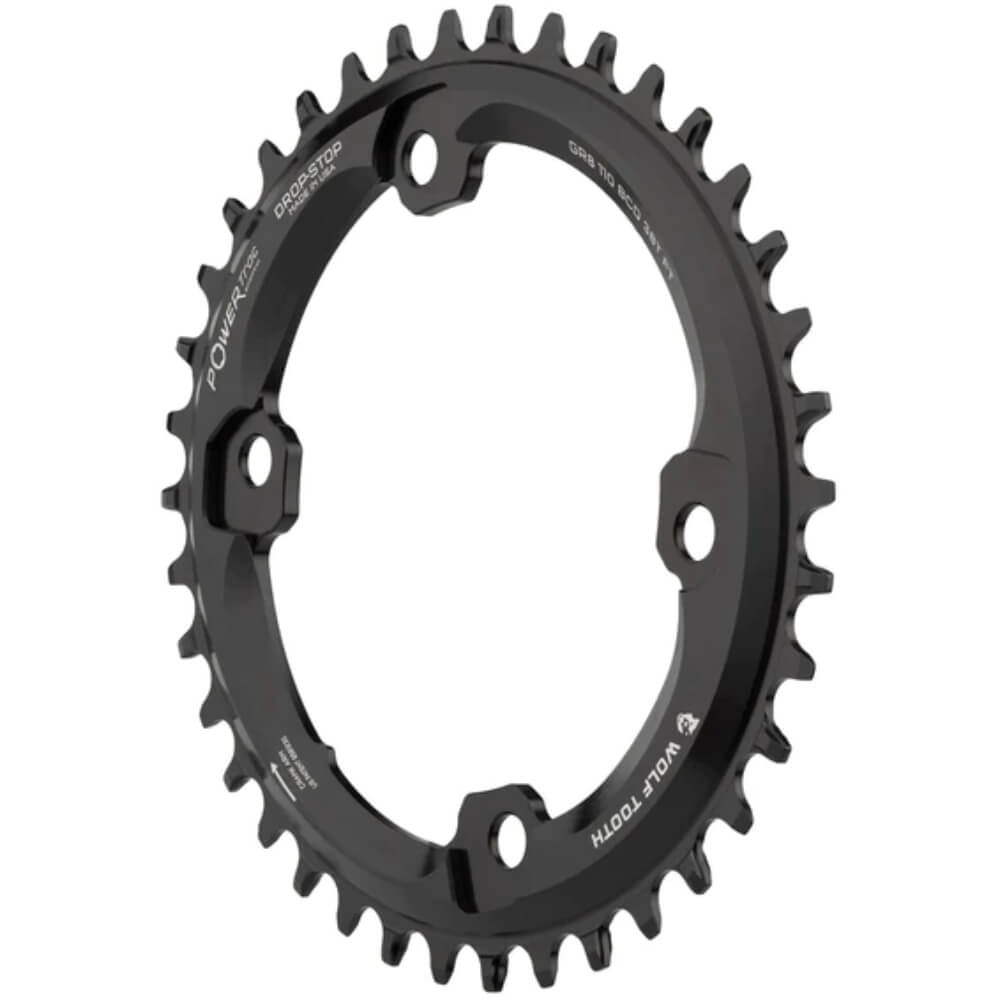An image of a black elliptical Wolf Tooth 1x chainring on a white background from the side.